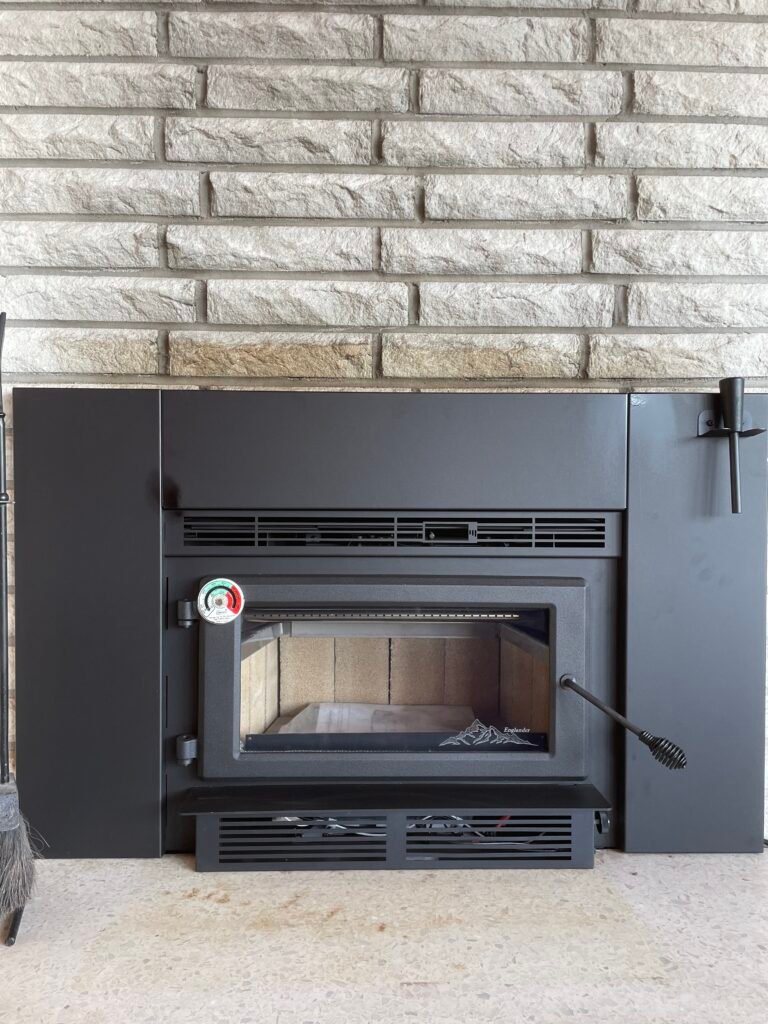 Certified inspected wood stove insert installation from St. Nicks Chimney, upgrading the current open fireplace for better efficiency and heat.